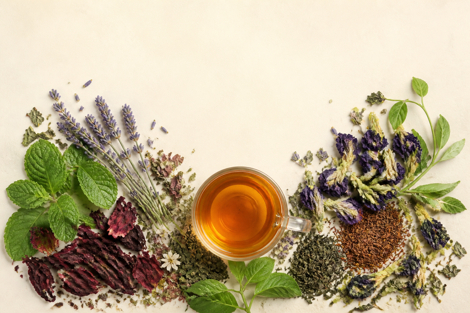 Whole Gudheal botanicals arranged around a glass cup
